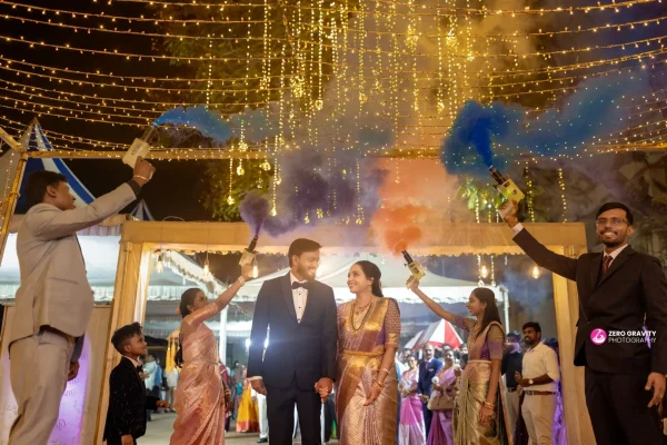 Newlywed couple posing elegantly before sparkling fairy-light backdrop